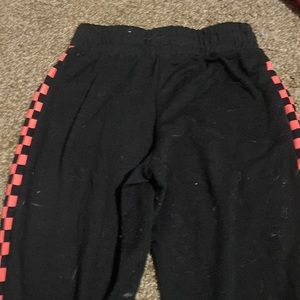Rue 21 black and pink sweatpants checkerboard side decal